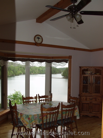 Cottage dining room overlooking Malone Bay,
       Lac des trente et un milles (31 miles lake),
       Bouchette, Quebec