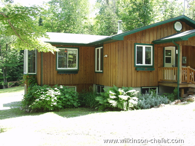 Cottage front exterior during the Summer,
       Lac des trente et un milles (31 miles lake),
       Bouchette, Quebec